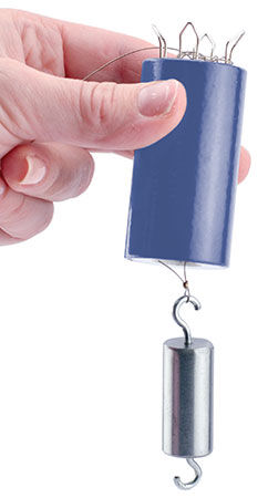 Weight hooked onto wire in wire knitter